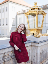 a lady wears a red mandarin collar crop jacket with a matching mini skirt